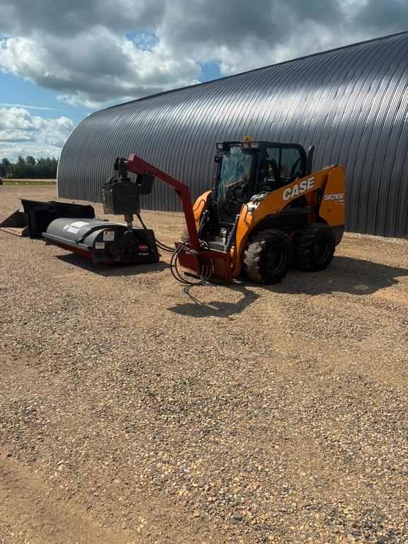 Case skid steer with a sweeper attachment