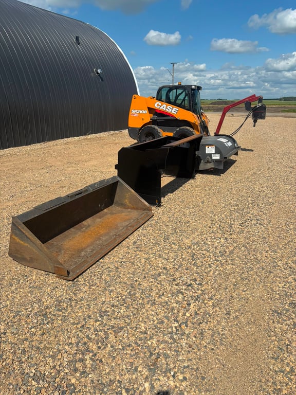 Skid steer with bucket and attachments