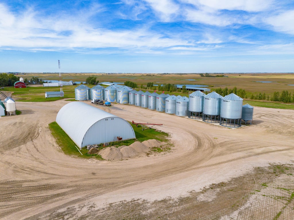 A storage building in front of rows of grain bins on the Lumsden farm