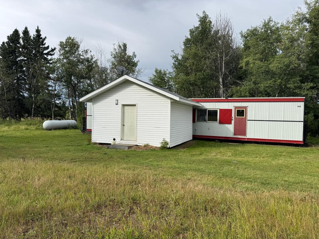 The mobile home and propane tank on the Torch River pasture yard