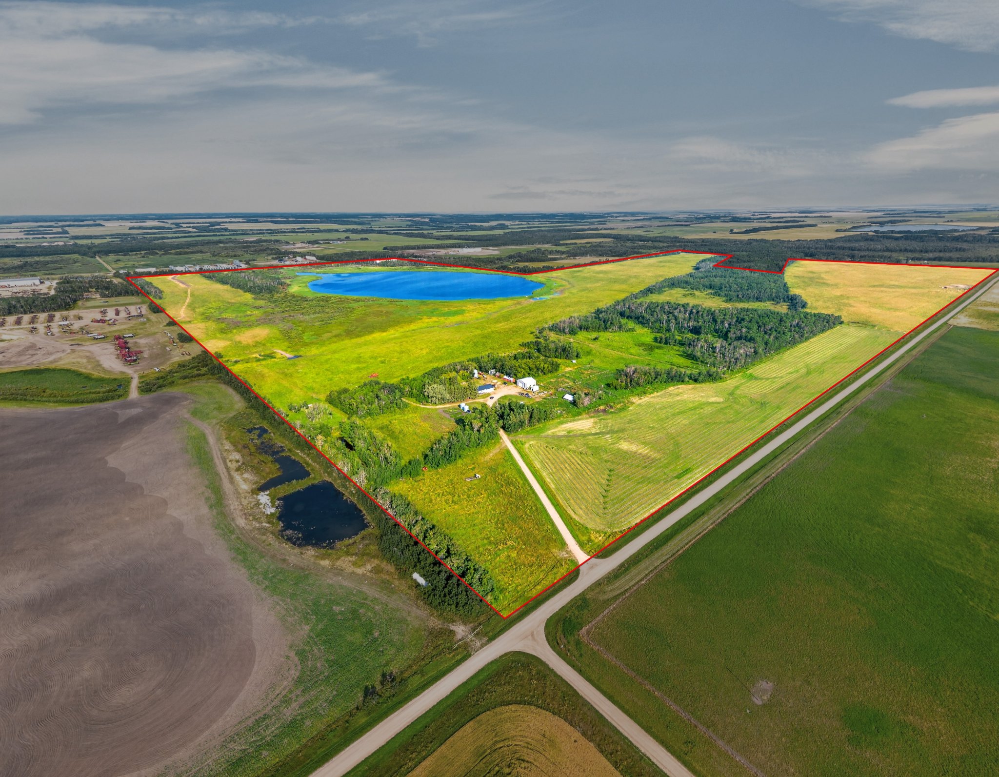 Aerial view of the Lefebvre land and yard site with the three quarters outlined from the road corner