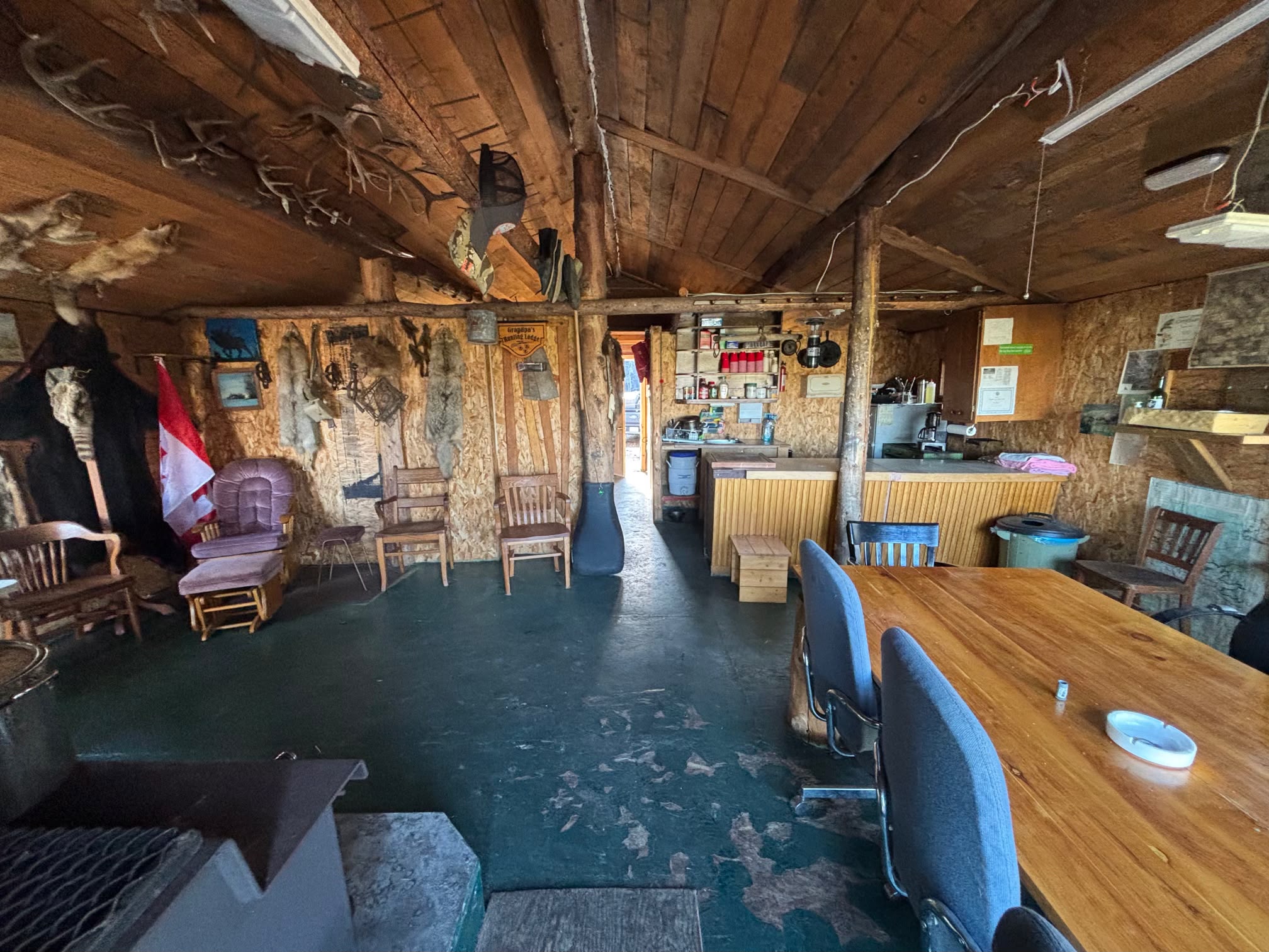 Interior of log cabin with dining table and kitchen