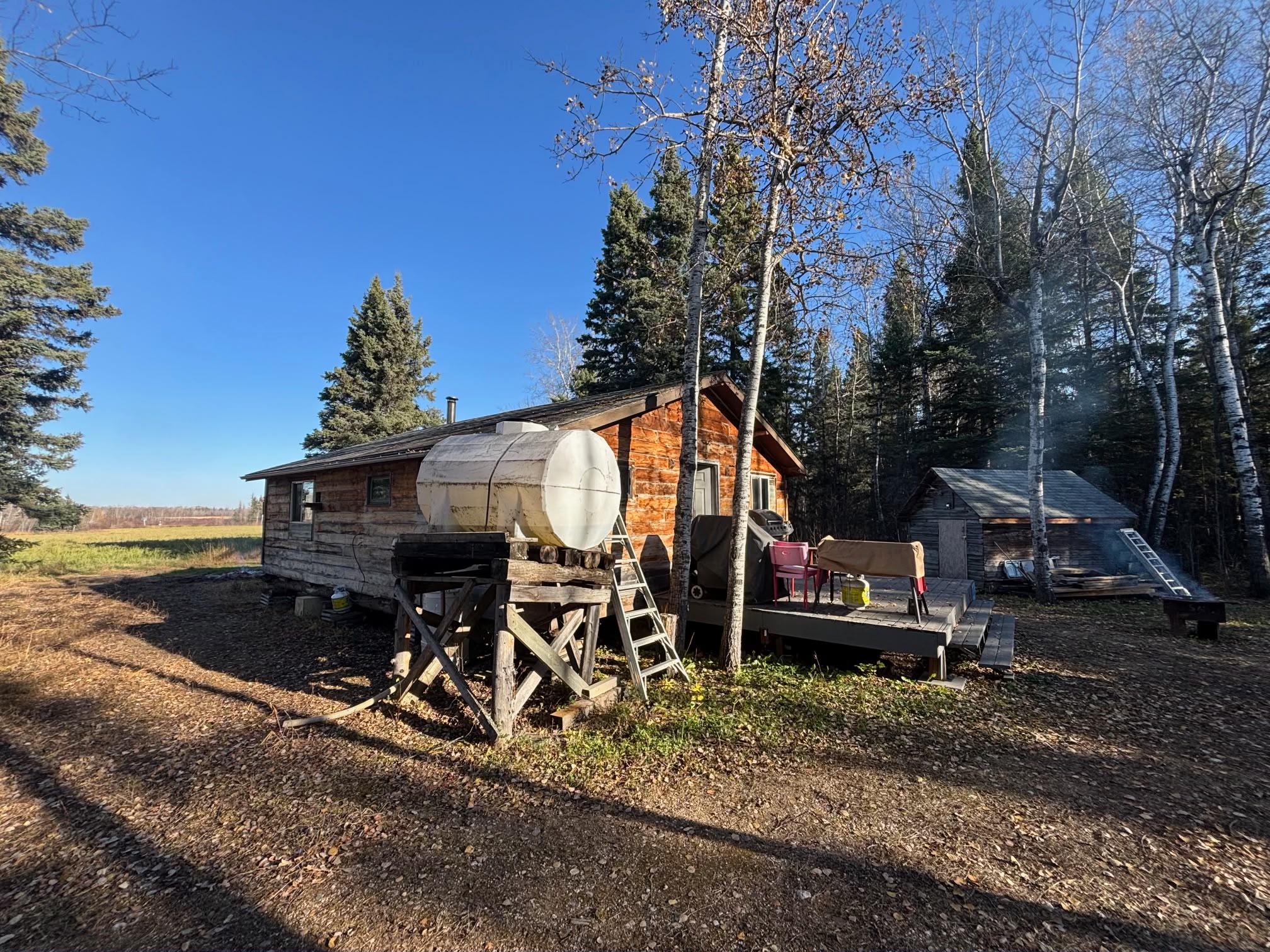 Water tank and cabin with solar panels in forest